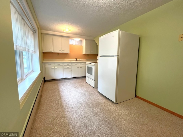 1277 Shakopee Ave E, Shakopee, MN 55379 - kitchen with white appliances, a textured ceiling, a sink, light countertops, and white cabinetry