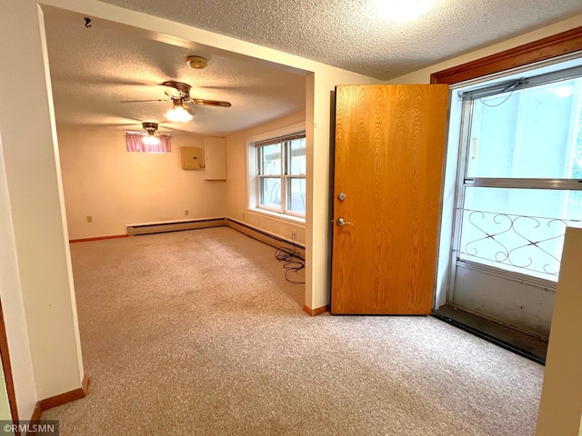 1277 Shakopee Ave E, Shakopee, MN 55379 - carpeted spare room with baseboards, a textured ceiling, a baseboard heating unit, and a smoke detector