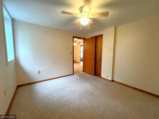 1277 Shakopee Ave E, Shakopee, MN 55379 - unfurnished room featuring light carpet, ceiling fan, healthy amount of natural light, and baseboards