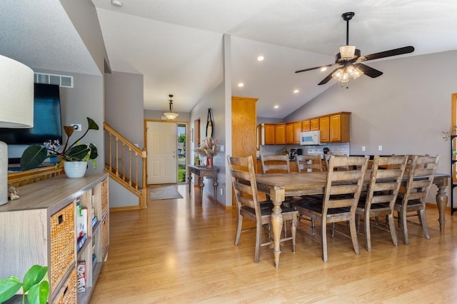 6445 Coryell Ct, Inver Grove Heights, MN 55076 - dining space featuring light wood finished floors, a ceiling fan, stairway, vaulted ceiling, and recessed lighting
