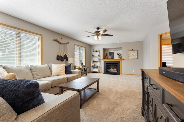 6445 Coryell Ct, Inver Grove Heights, MN 55076 - living room featuring a ceiling fan, light colored carpet, a textured ceiling, built in features, and a fireplace with flush hearth