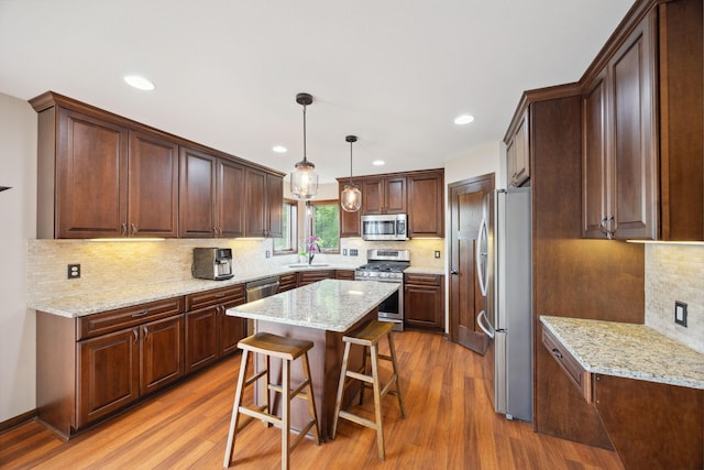 231 Winkler Trl, Cologne, MN 55322 - kitchen with appliances with stainless steel finishes, a sink, wood finished floors, tasteful backsplash, and recessed lighting