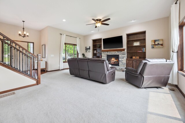 231 Winkler Trl, Cologne, MN 55322 - living room with light colored carpet, a chandelier, baseboards, a stone fireplace, and recessed lighting