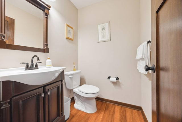 231 Winkler Trl, Cologne, MN 55322 - half bathroom featuring toilet, vanity, wood finished floors, and baseboards