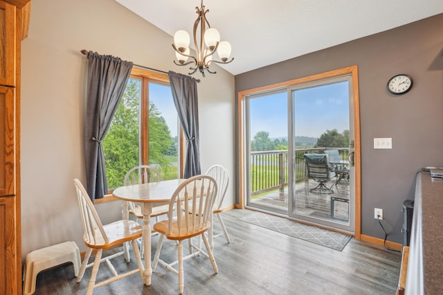 881 217th St, Osceola, WI 54020 - dining room featuring vaulted ceiling, baseboards, a chandelier, and wood finished floors