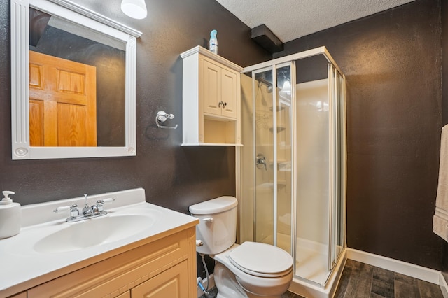 881 217th St, Osceola, WI 54020 - bathroom with toilet, wood finished floors, a shower stall, vanity, and a textured ceiling