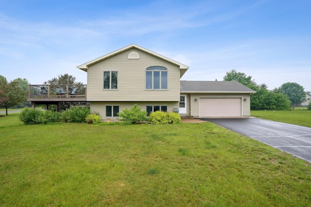 881 217th St, Osceola, WI 54020 - split level home with asphalt driveway, a front yard, a garage, and a wooden deck