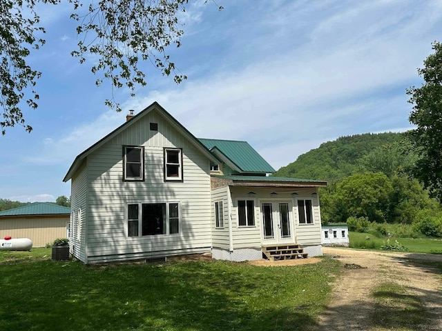 12283 County Road 31, Mount Vernon Twp, MN 55910 - back of house with a lawn, french doors, a chimney, and central AC