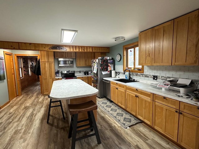 12283 County Road 31, Mount Vernon Twp, MN 55910 - kitchen featuring stainless steel appliances, a sink, backsplash, and wood finished floors