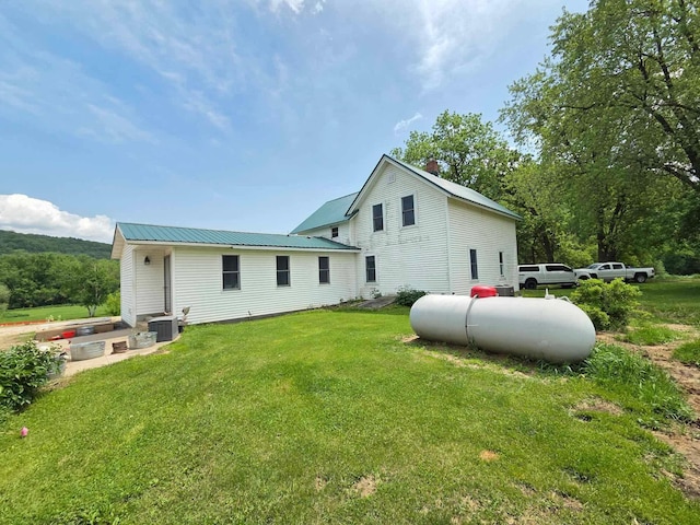12283 County Road 31, Mount Vernon Twp, MN 55910 - rear view of property with a yard, metal roof, and central AC unit