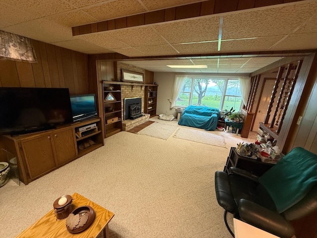 26813 Scenic Byway Rd, Faxon Twp, MN 56011 - carpeted living room featuring a drop ceiling, wood walls, and a wood stove