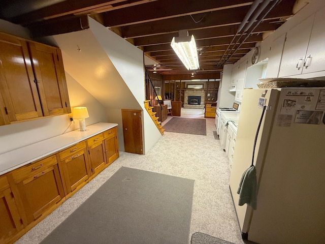 26813 Scenic Byway Rd, Faxon Twp, MN 56011 - kitchen featuring white appliances, brown cabinetry, light countertops, open floor plan, and a fireplace