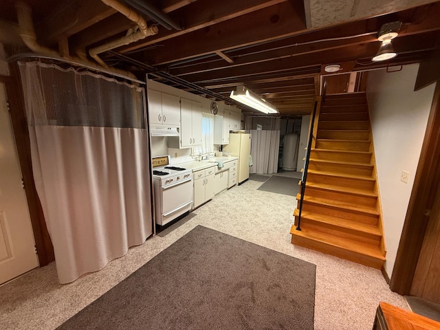26813 Scenic Byway Rd, Faxon Twp, MN 56011 - finished basement featuring freestanding refrigerator, stairway, a sink, and water heater