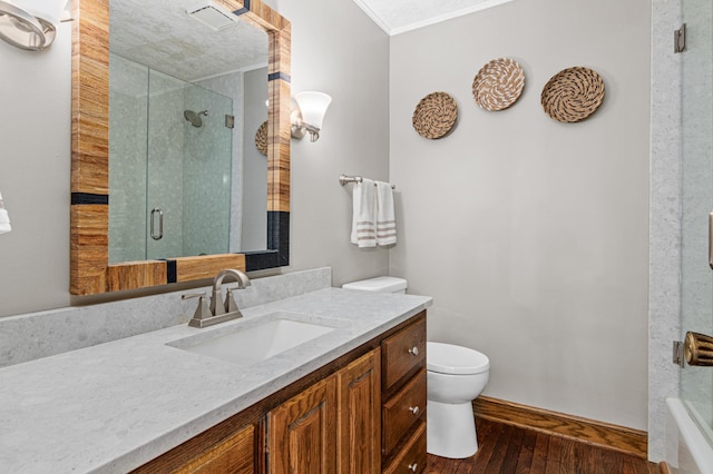 6230 Elm Ridge Cir, Corcoran, MN 55340 - bathroom with toilet, vanity, a shower with door, hardwood / wood-style floors, and ornamental molding