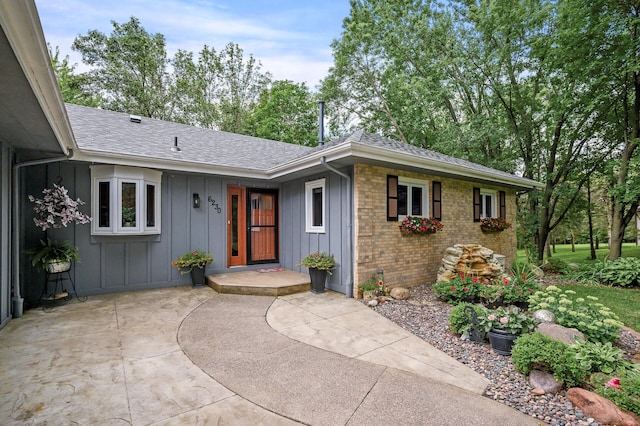 6230 Elm Ridge Cir, Corcoran, MN 55340 - view of front of property featuring board and batten siding, a shingled roof, and brick siding