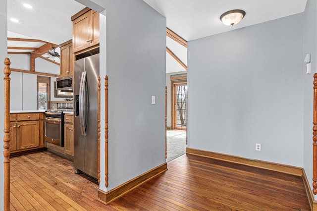 6230 Elm Ridge Cir, Corcoran, MN 55340 - kitchen with stainless steel appliances, healthy amount of natural light, light wood finished floors, baseboards, and vaulted ceiling