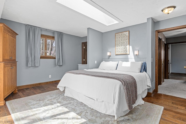 6230 Elm Ridge Cir, Corcoran, MN 55340 - bedroom featuring a skylight, wood finished floors, and baseboards