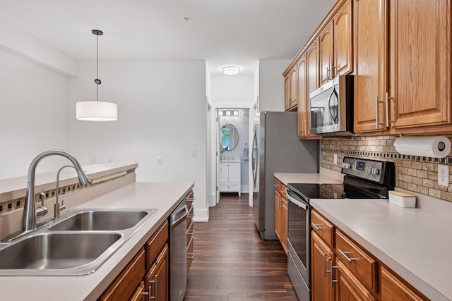 1924 Shamrock Pl, Chaska, MN 55318 - kitchen featuring stainless steel appliances, tasteful backsplash, dark wood-type flooring, decorative light fixtures, and light countertops