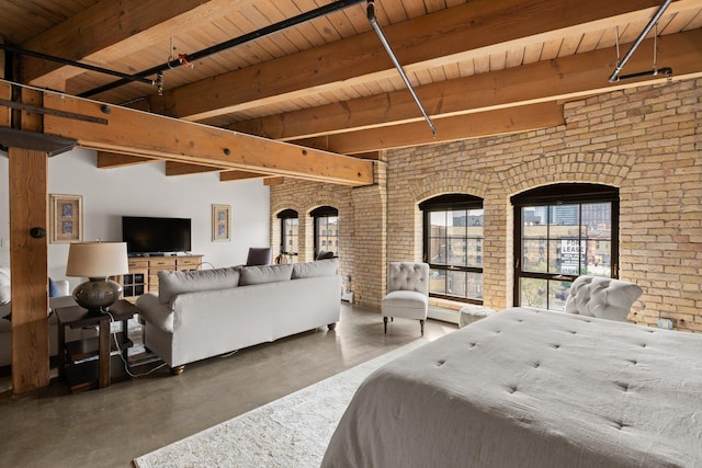 404 Washington Ave N Unit 504, Minneapolis, MN 55401 - bedroom featuring concrete floors, brick wall, and wood ceiling with exposed beams