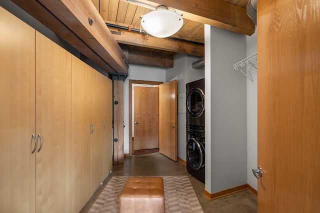 404 Washington Ave N Unit 504, Minneapolis, MN 55401 - washroom featuring stacked washer and clothes dryer, wood ceiling, and baseboards