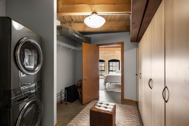 404 Washington Ave N Unit 504, Minneapolis, MN 55401 - laundry room featuring stacked washer / drying machine, wooden ceiling, and carpet flooring