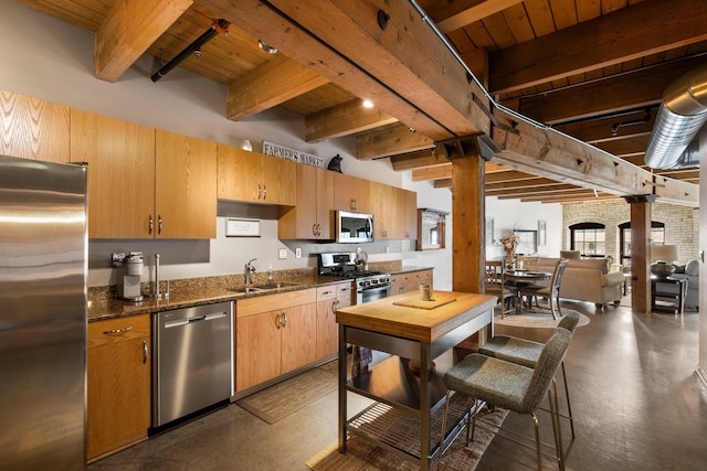 404 Washington Ave N Unit 504, Minneapolis, MN 55401 - kitchen featuring appliances with stainless steel finishes, wooden ceiling with exposed beams, a sink, and dark stone countertops