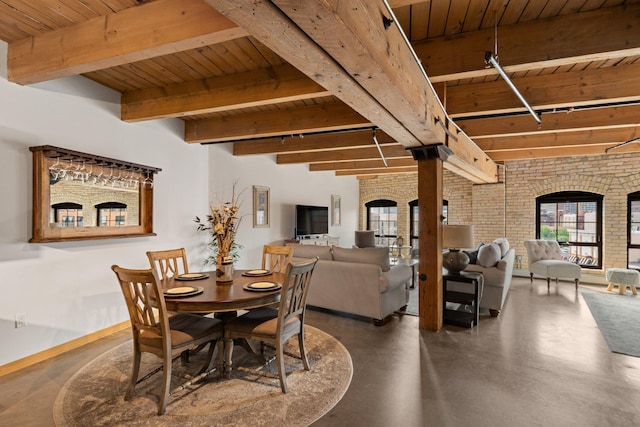 404 Washington Ave N Unit 504, Minneapolis, MN 55401 - dining area featuring wooden ceiling with exposed beams, brick wall, concrete floors, and baseboards