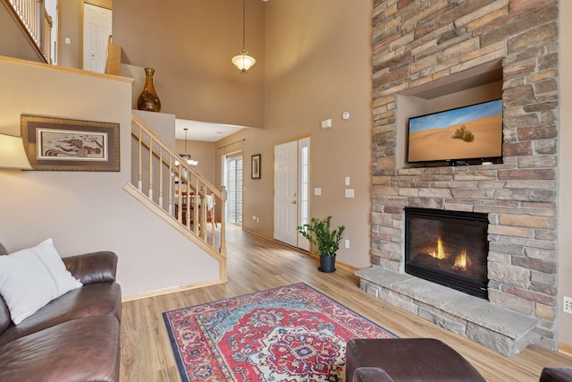 17829 66th Ave N, Maple Grove, MN 55311 - living room with stairs, wood finished floors, a fireplace, and a high ceiling