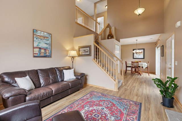 17829 66th Ave N, Maple Grove, MN 55311 - living area featuring stairs, a towering ceiling, wood finished floors, and a chandelier