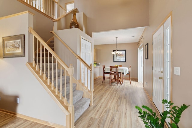17829 66th Ave N, Maple Grove, MN 55311 - foyer entrance with wood finished floors, stairs, a high ceiling, and a chandelier