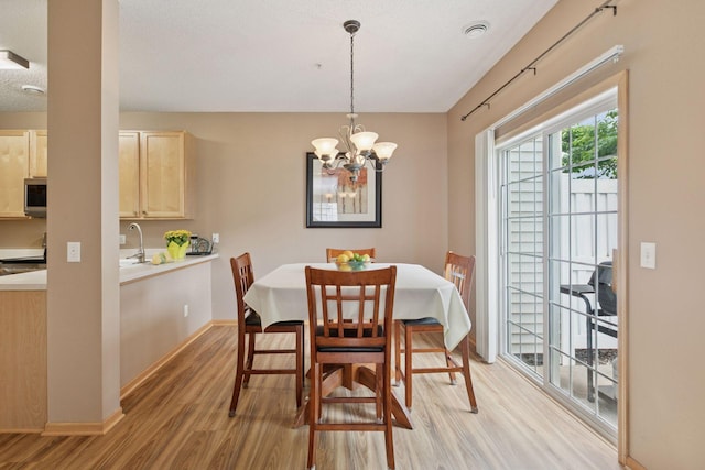 17829 66th Ave N, Maple Grove, MN 55311 - dining room with light wood-style floors and a chandelier