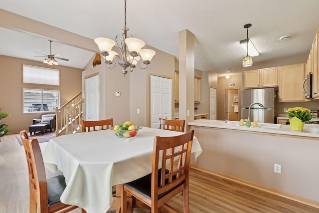 17829 66th Ave N, Maple Grove, MN 55311 - dining area with light wood-type flooring, a ceiling fan, a chandelier, and a textured ceiling