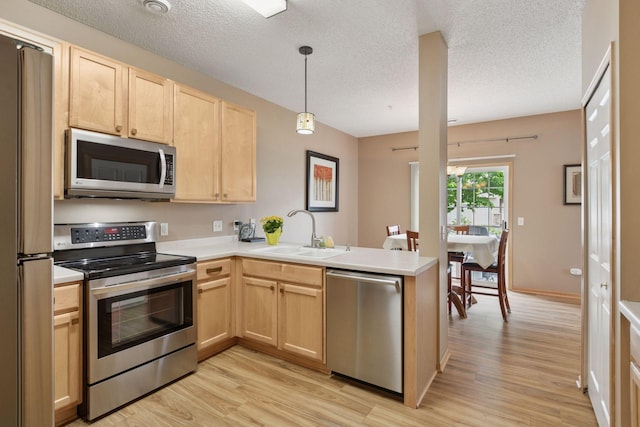 17829 66th Ave N, Maple Grove, MN 55311 - kitchen with appliances with stainless steel finishes, light brown cabinets, a peninsula, light wood finished floors, and a textured ceiling