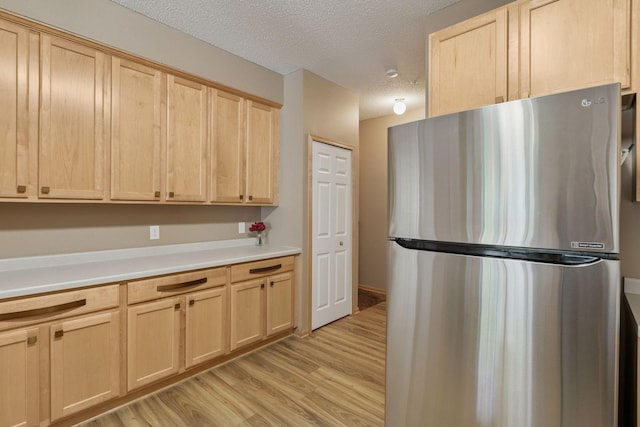 17829 66th Ave N, Maple Grove, MN 55311 - kitchen with freestanding refrigerator, light brown cabinets, light wood-type flooring, a textured ceiling, and light countertops