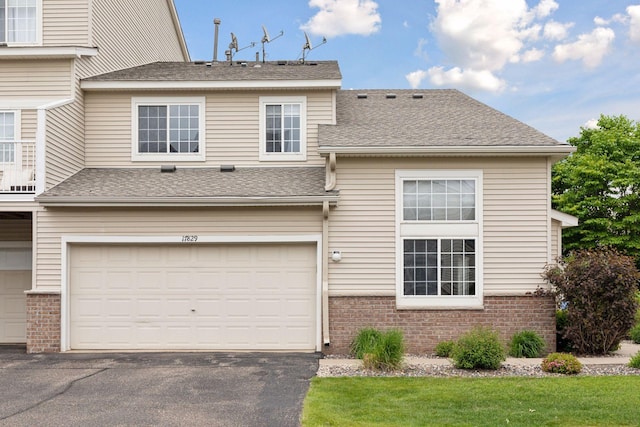17829 66th Ave N, Maple Grove, MN 55311 - view of front facade with brick siding, an attached garage, driveway, and roof with shingles