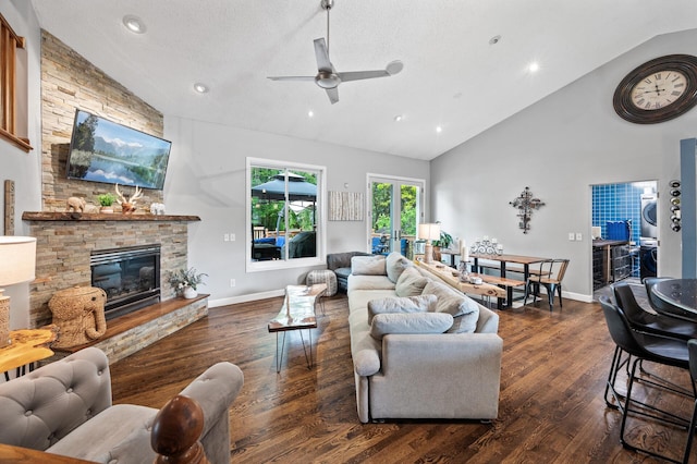 1439 Oakdale Ave W, Saint Paul, MN 55118 - living area featuring stacked washer and clothes dryer, ceiling fan, wood finished floors, high vaulted ceiling, and a fireplace