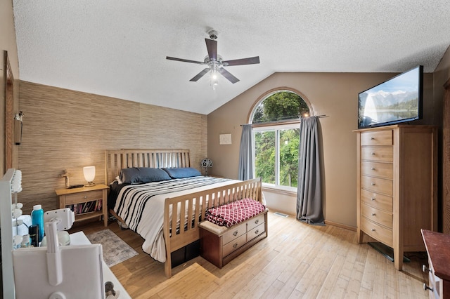 1439 Oakdale Ave W, Saint Paul, MN 55118 - bedroom with baseboards, an accent wall, vaulted ceiling, light wood finished floors, and a textured ceiling