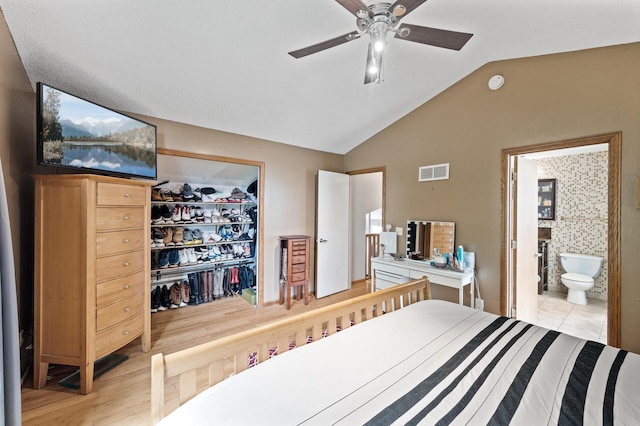 1439 Oakdale Ave W, Saint Paul, MN 55118 - bedroom featuring lofted ceiling, a walk in closet, a closet, ensuite bathroom, and a ceiling fan