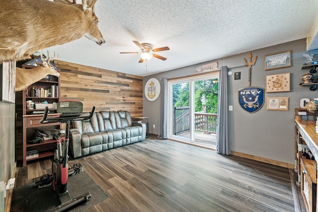 1439 Oakdale Ave W, Saint Paul, MN 55118 - living area with a ceiling fan, baseboards, a textured ceiling, wood finished floors, and wooden walls