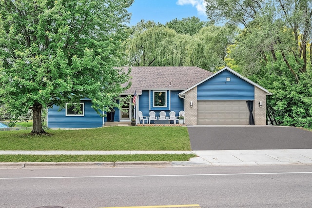 1439 Oakdale Ave W, Saint Paul, MN 55118 - view of front of home with an attached garage, driveway, a front lawn, brick siding, and a shingled roof