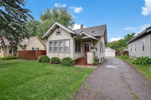 3314 Aldrich Ave N, Minneapolis, MN 55412 - bungalow featuring a chimney, a detached garage, an outdoor structure, stucco siding, and a shingled roof