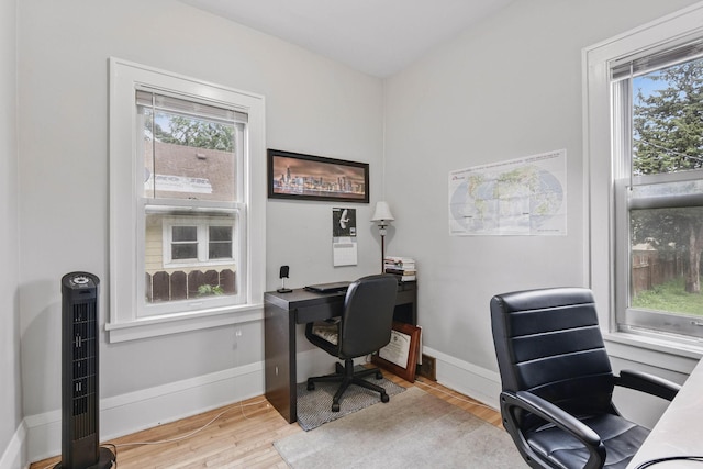 3314 Aldrich Ave N, Minneapolis, MN 55412 - home office with healthy amount of natural light, wood finished floors, and baseboards