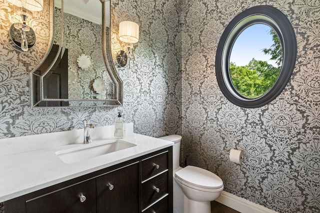 9320 Abigail Ct, Inver Grove Heights, MN 55077 - bathroom featuring wallpapered walls, toilet, vanity, and ornamental molding