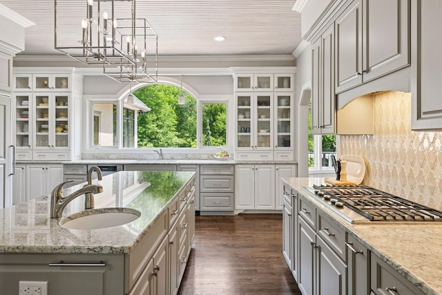 9320 Abigail Ct, Inver Grove Heights, MN 55077 - kitchen featuring a sink, glass insert cabinets, decorative backsplash, a chandelier, and crown molding