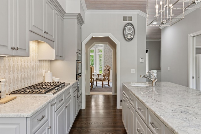 9320 Abigail Ct, Inver Grove Heights, MN 55077 - kitchen with a sink, stainless steel gas stovetop, dark wood finished floors, decorative backsplash, and light stone countertops