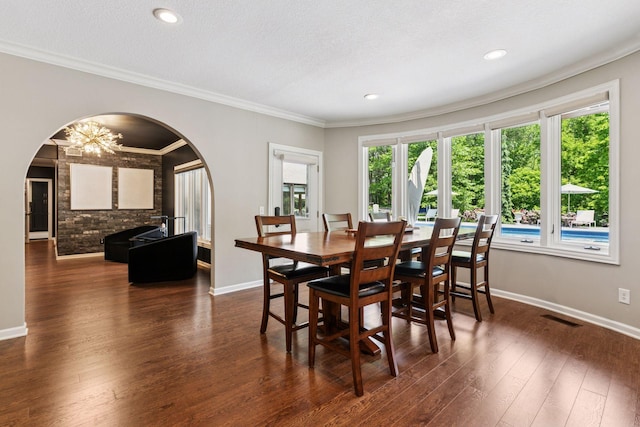 9320 Abigail Ct, Inver Grove Heights, MN 55077 - dining area featuring arched walkways, dark wood-style flooring, baseboards, a chandelier, and ornamental molding