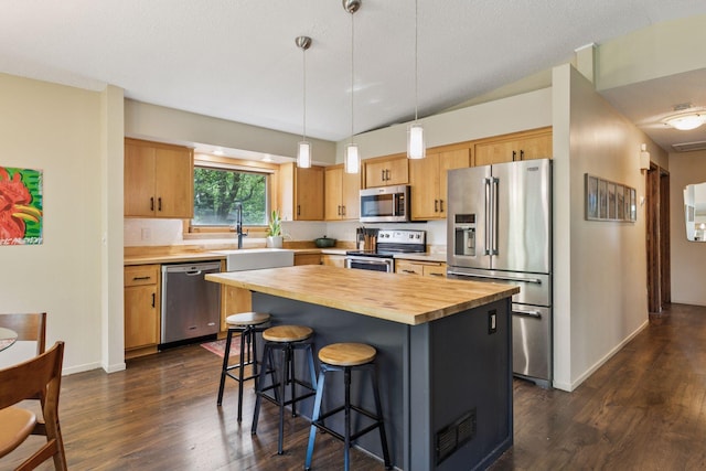 164 Wendy Ct, Shoreview, MN 55126 - kitchen with stainless steel appliances, butcher block countertops, a sink, dark wood-style flooring, and a breakfast bar