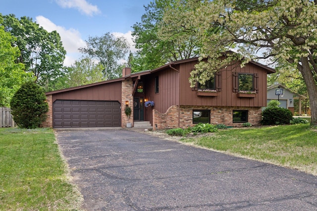 164 Wendy Ct, Shoreview, MN 55126 - view of front of property featuring brick siding, driveway, a chimney, a garage, and a front yard