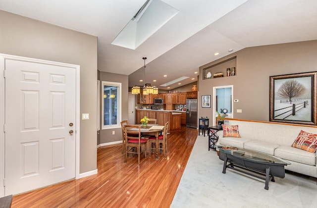 706 Pershing Ave N, New Prague, MN 56071 - living area featuring vaulted ceiling, light wood-style flooring, recessed lighting, and baseboards