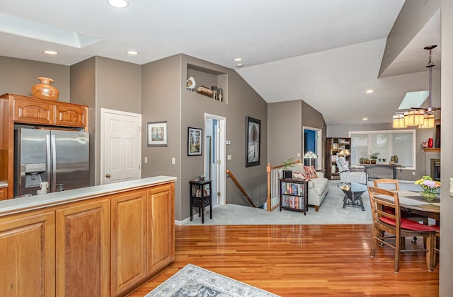 706 Pershing Ave N, New Prague, MN 56071 - kitchen with stainless steel fridge, open floor plan, lofted ceiling, light wood-style floors, and recessed lighting